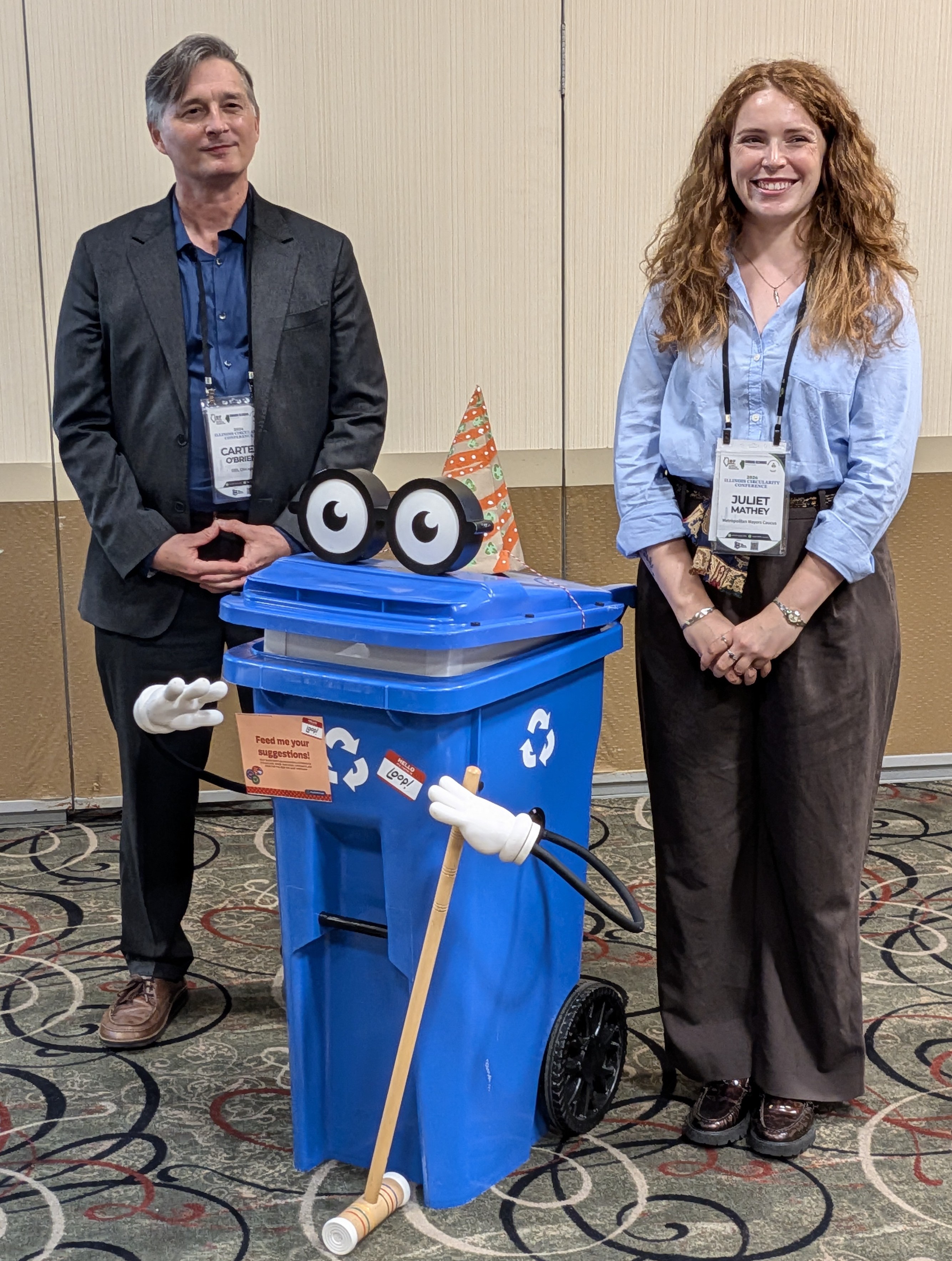 Carter O'Brien and Juliet Mathey standing with Loop the recycling cart at ICC 2026